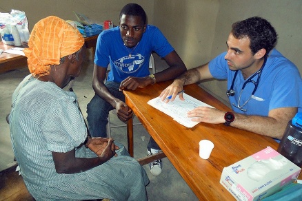 Zoom image: Medical student Vinny Polsinelli meets with a Haitian patient. 