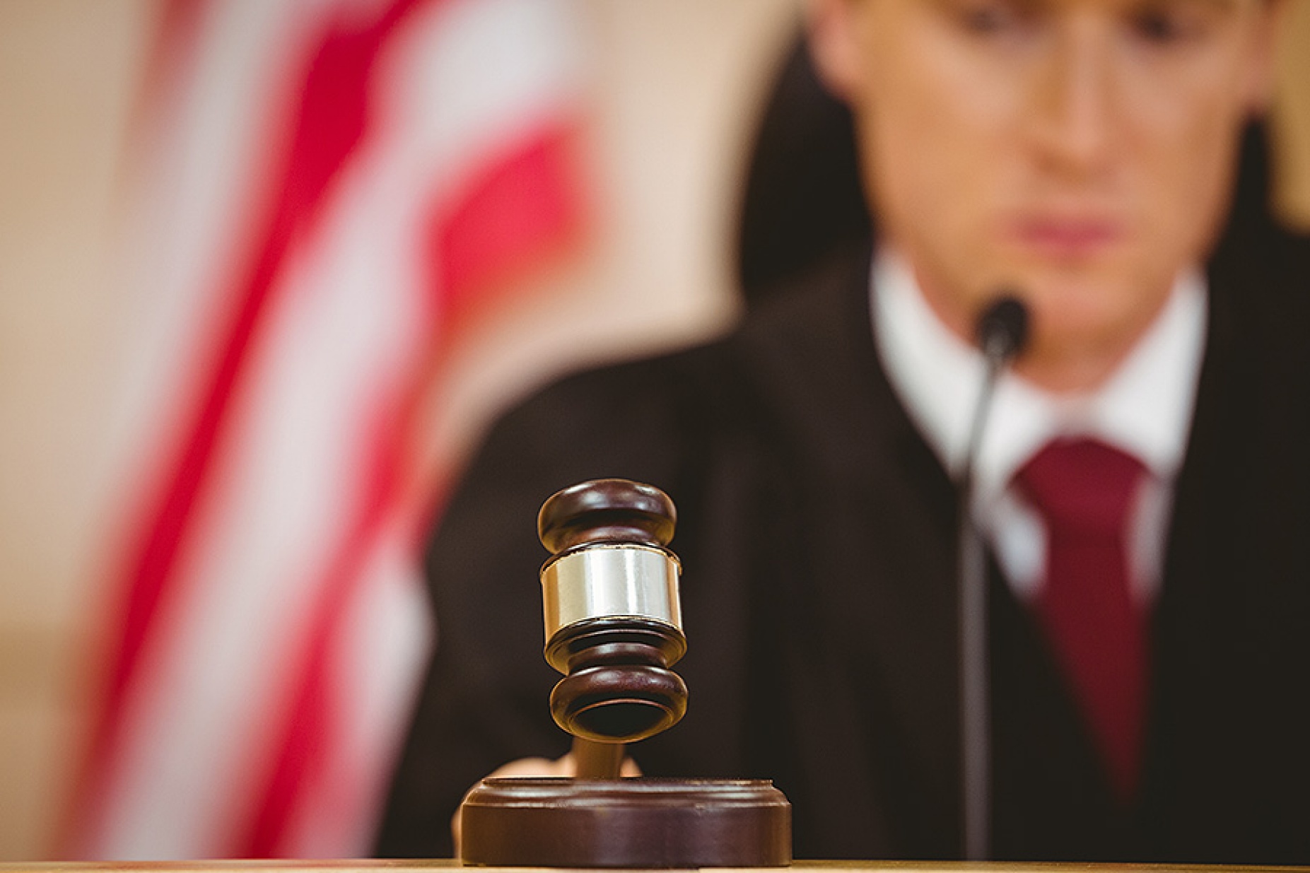Stern judge about to bang gavel on sounding block. 