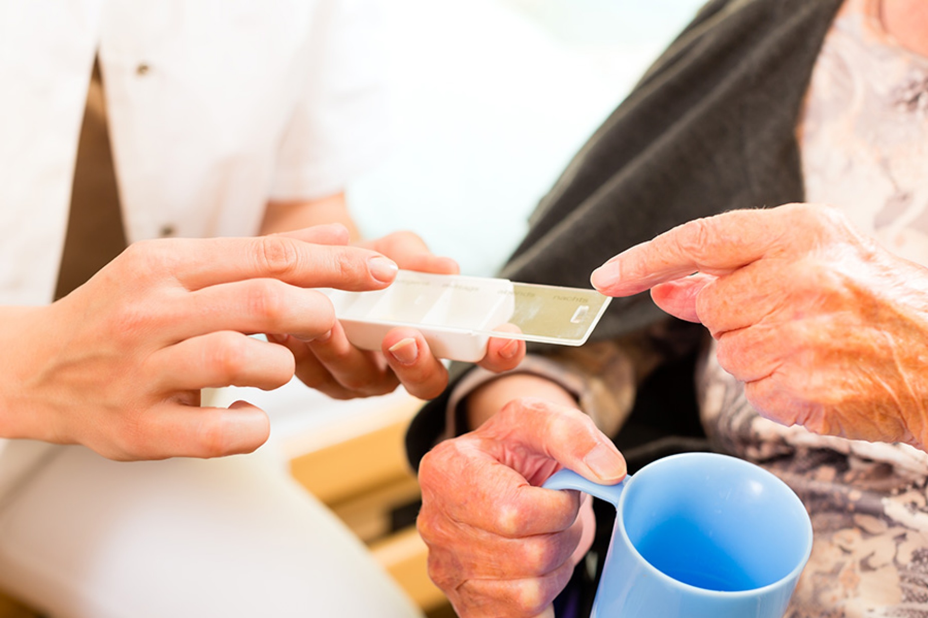 hands of doctor and elderly patient.