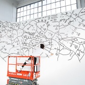 Shantell Martin on a cherry picker drawing on a white wall for a special event for the opening of Saks Fifth Avenue's Toronto store in 2015. 
