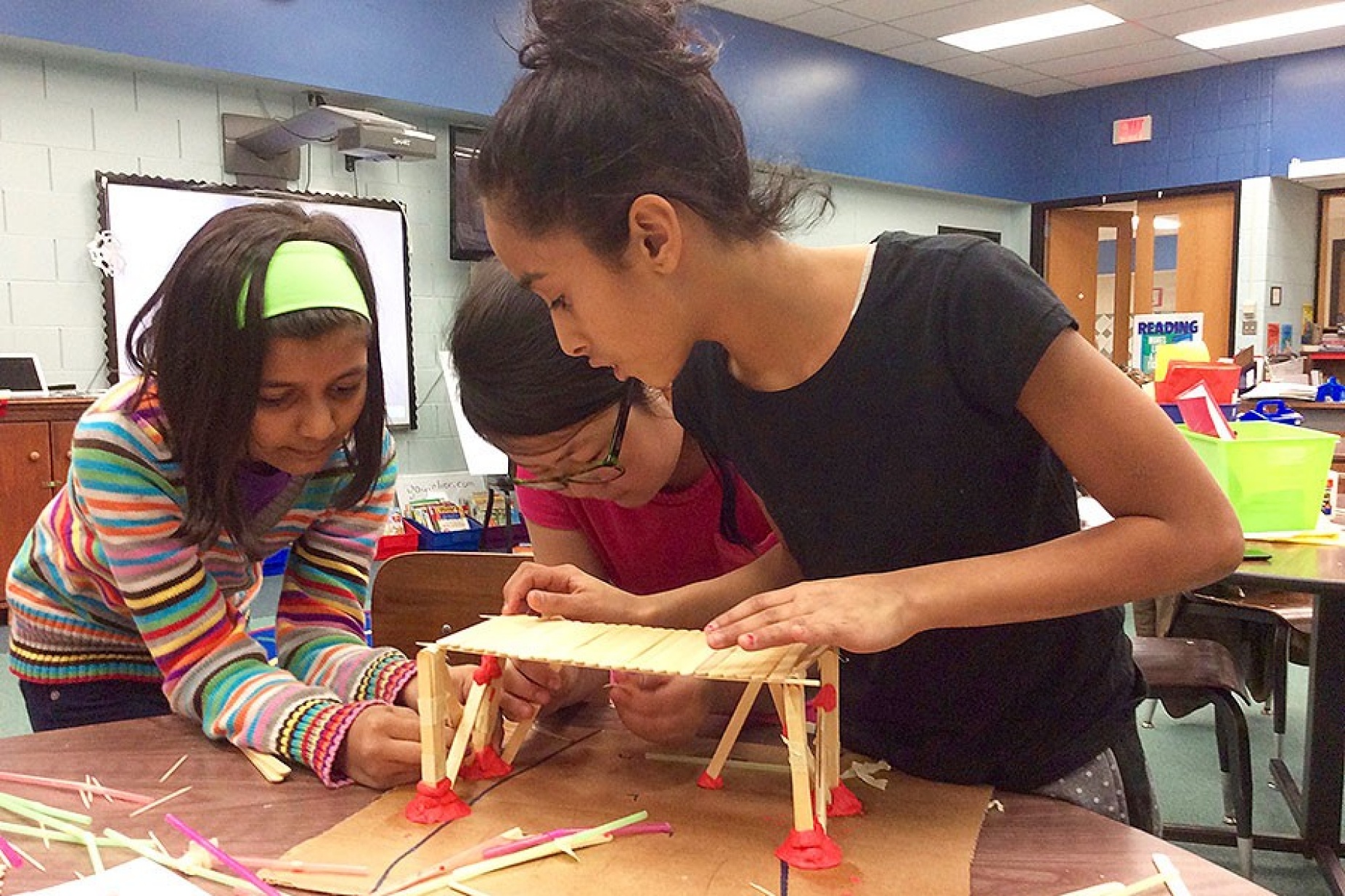 girls working together on a STEM project. 