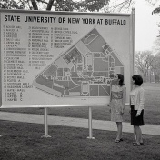 Two female students examine a large outdoor map of the South Campus in 1967. 