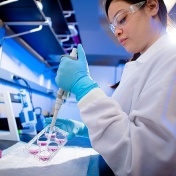 Darleny Lizardo, a PhD student in chemistry, performing an experiment in the Natural Sciences Complex on North Campus. 