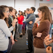 Participants in the Global Health Equity Food Ideas Lab face each other in two lines to talk about potential research ideas. 