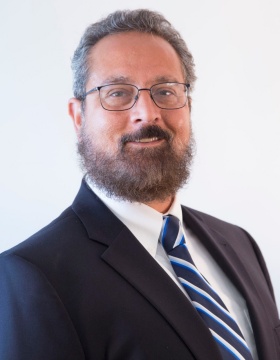 portrait of Michael LaMonte wearing suit and tie. 