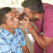 Medical student Aman Cheema examines a patient with vision abnormalities. 