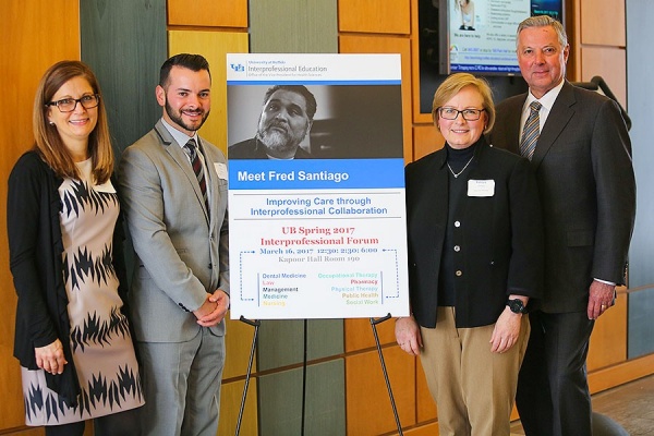 Lisa Jane Jacobsen, Nicholas Fusco, Patricia Ohtake and Michael Cain stand by a poster promoting the film "Meet Fred Santiago" that IPE participants watched during the forum. 