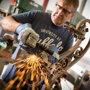 Brian Koyn grinds years of rust off the newly discovered lantern. 