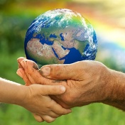 adult hands passing globe to child's hands. 