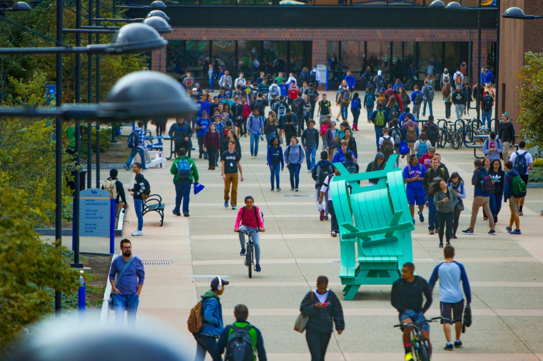 Crowds of students walking along Founders Plaza. 