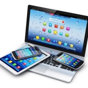 Pile of electronics -- laptop, tablet, phone. 