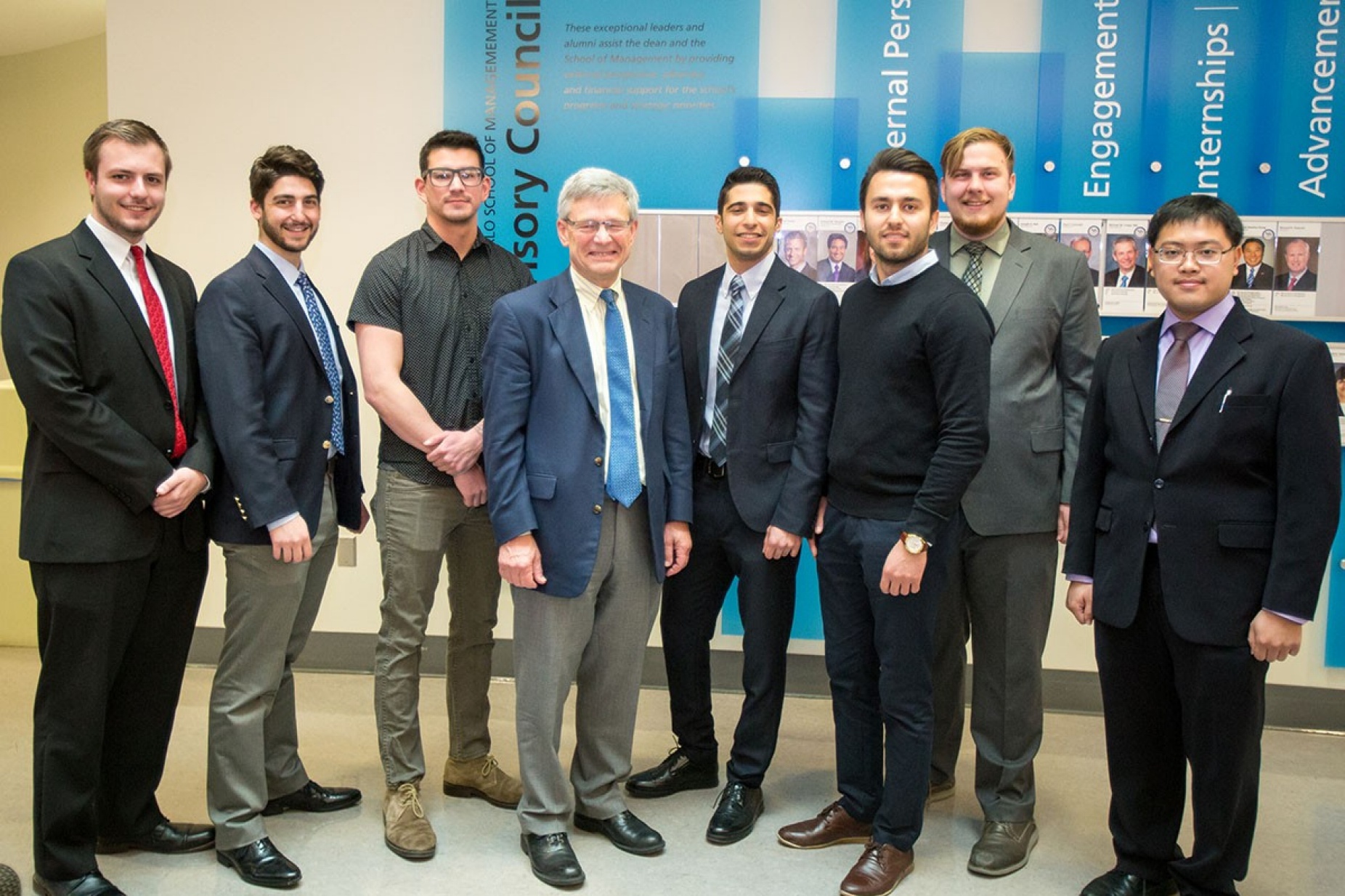 Winners of the Student Entrepreneur Fellowship Competition (eLab) stand with Provost Charles F. Zukoski in the Alfiero Center at the School of Management. 
