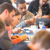 participants write down their ideas on post-it notes at the Buffalo ErieHack ideation session held in February. 