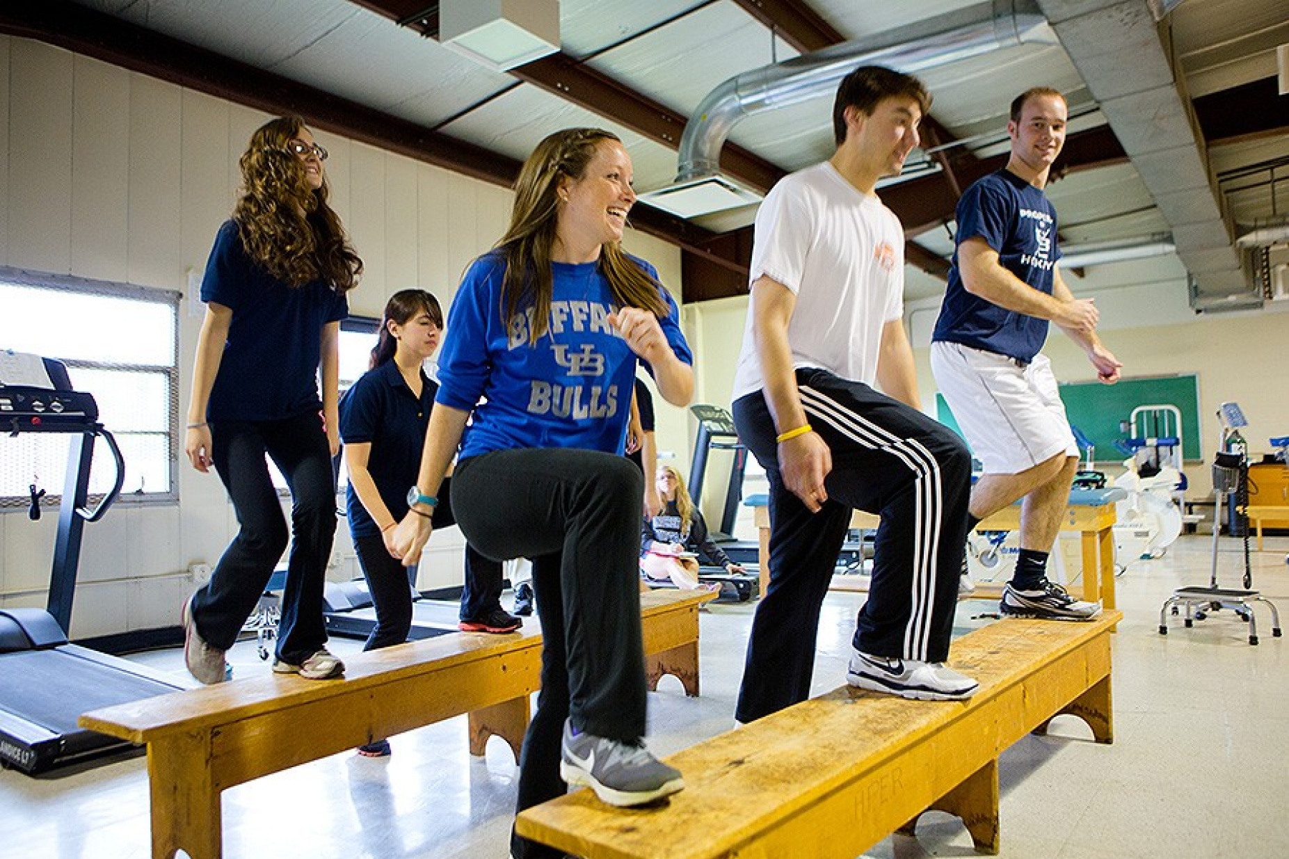 SHPPH students in a classroom setting, participating in an exercise routine. 