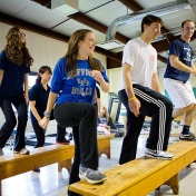SHPPH students in a classroom setting, participating in an exercise routine. 