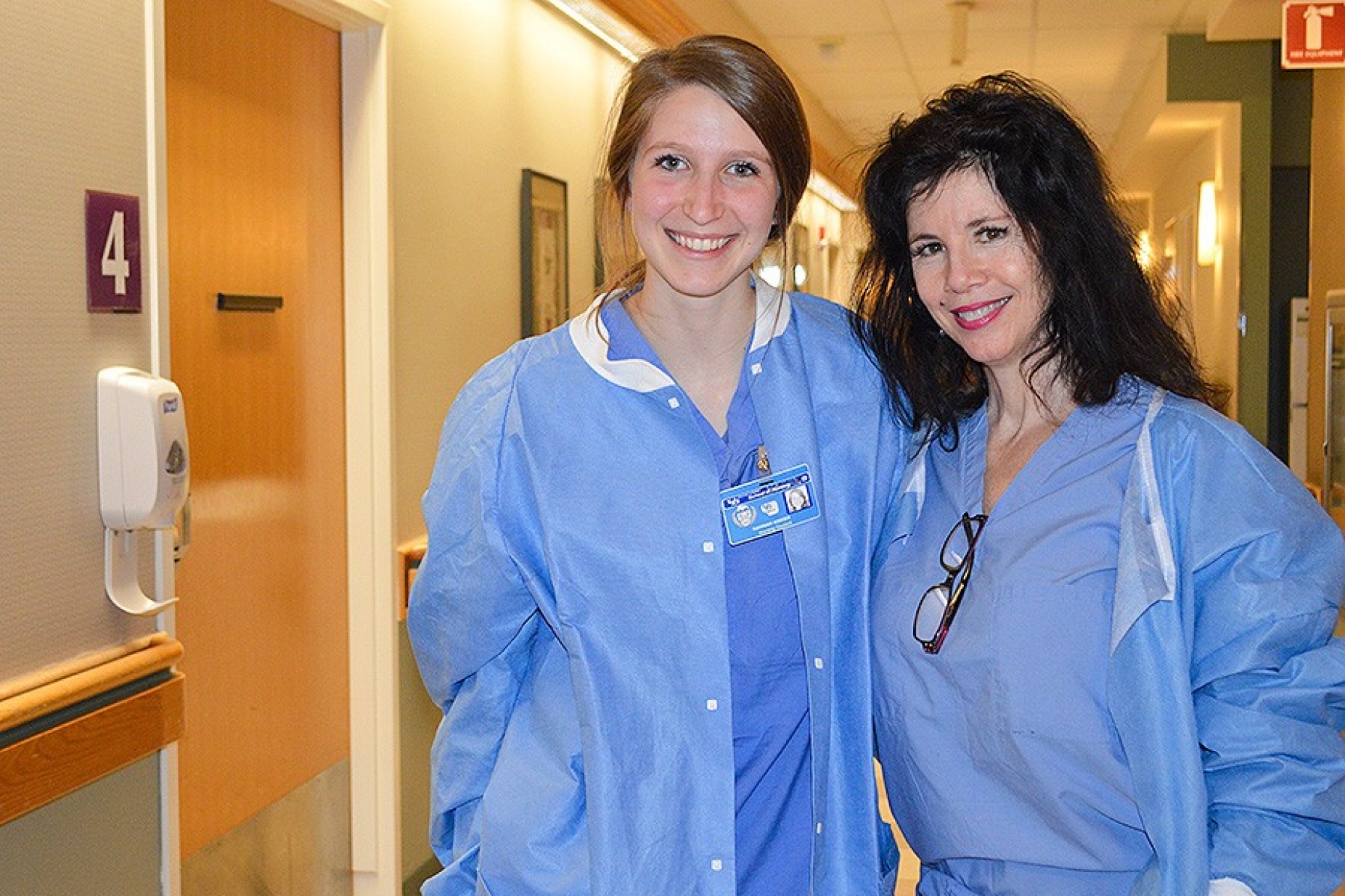 Nursing student Hannah Kisker (left) and Sisters Hospital nurse Susan Caruana in a hallway at Sisters. 
