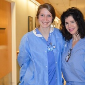 two nurses in the hallway of a hospital. 