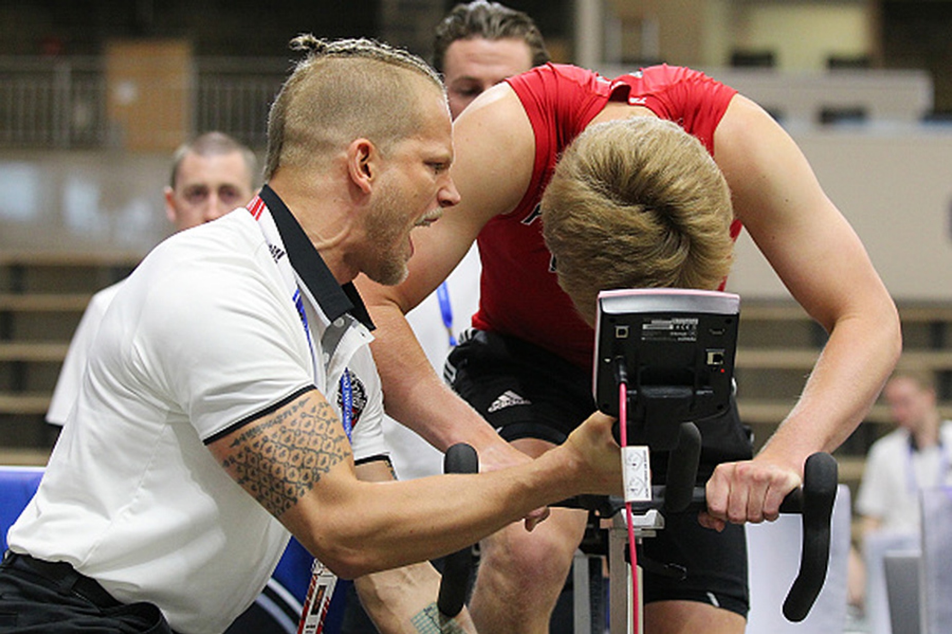 Jordan Marwin yells encouragement at a young hockey player riding a stationary bike. 