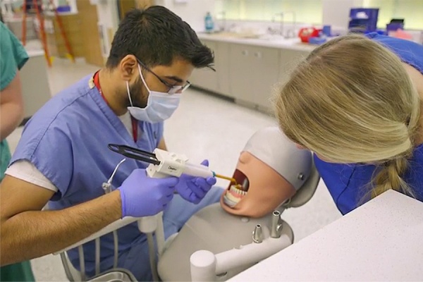 A dental student working on a "patient" in the new pre-clinical simulation center. 