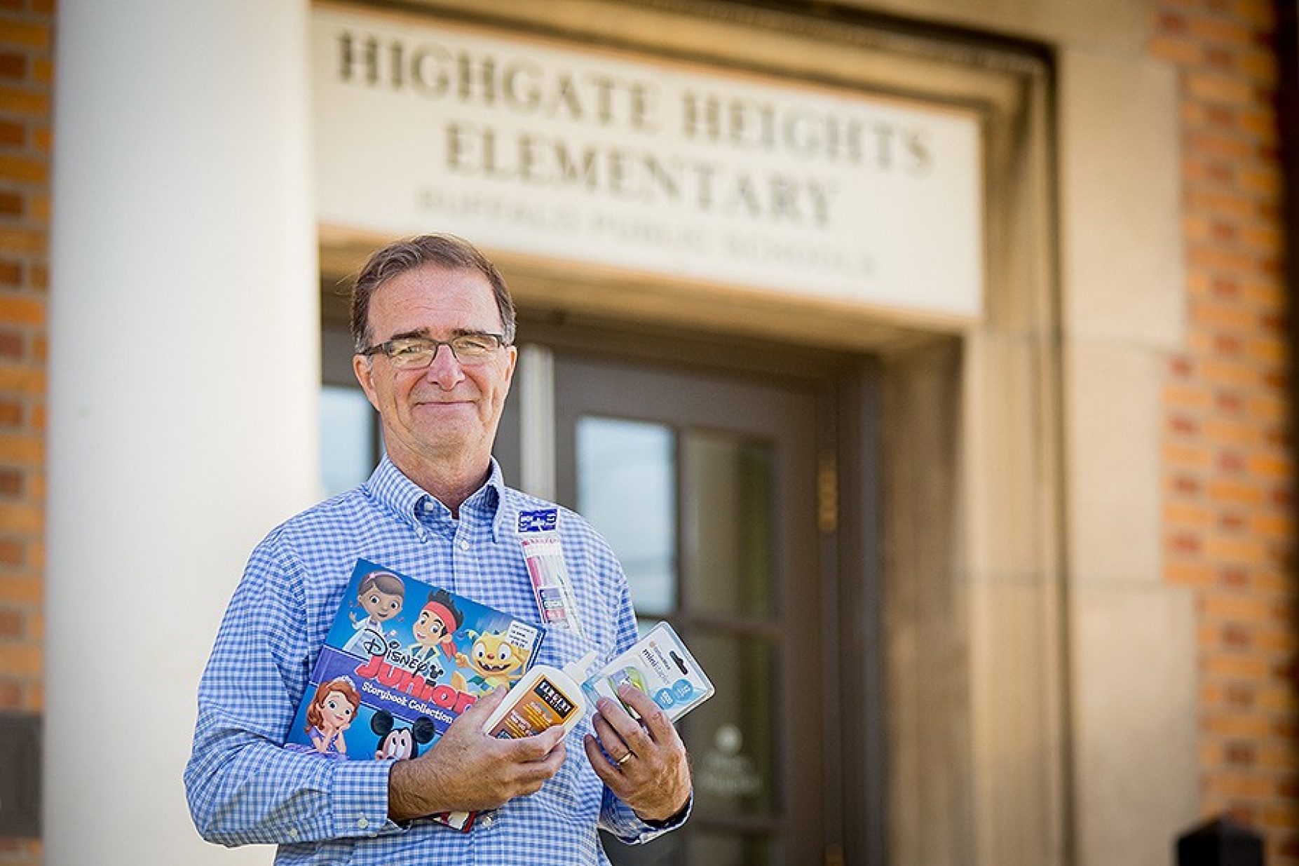 John Mika holding school supplies. 