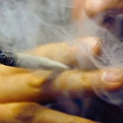 closeup of a man smoking marijuana. 