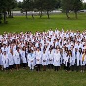 Jacobs School of Medicine and Biological Sciences' long white coat ceremony&mdash;new residents group photo. 