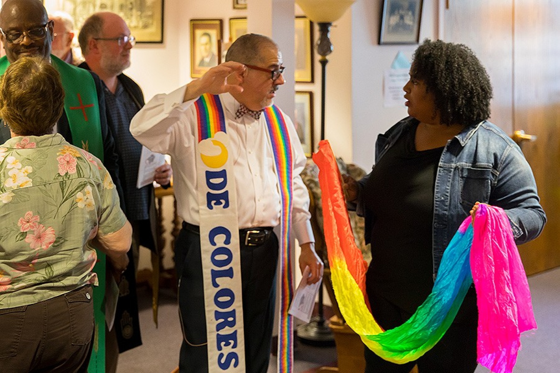 Pastor Justo Gonzalez and Danielle Johnson speak before the service.