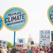 Protesters hold signs at Peoples Climate March, which backed action on climate change, in Washington DC on April 29, 2017. 