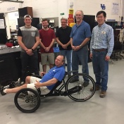 Curt Senf on his trike with UB students Caleb Walters and Austin Powers and Machine Shop staff William Macy, Gary Olson and Xinnan Peng. 
