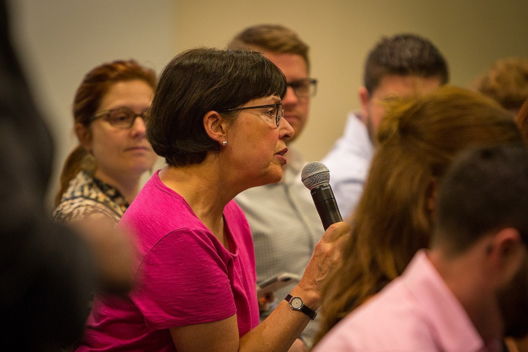 Audience member asks a question during the discussion.