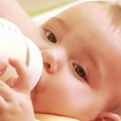 Baby drinking from a bottle. 