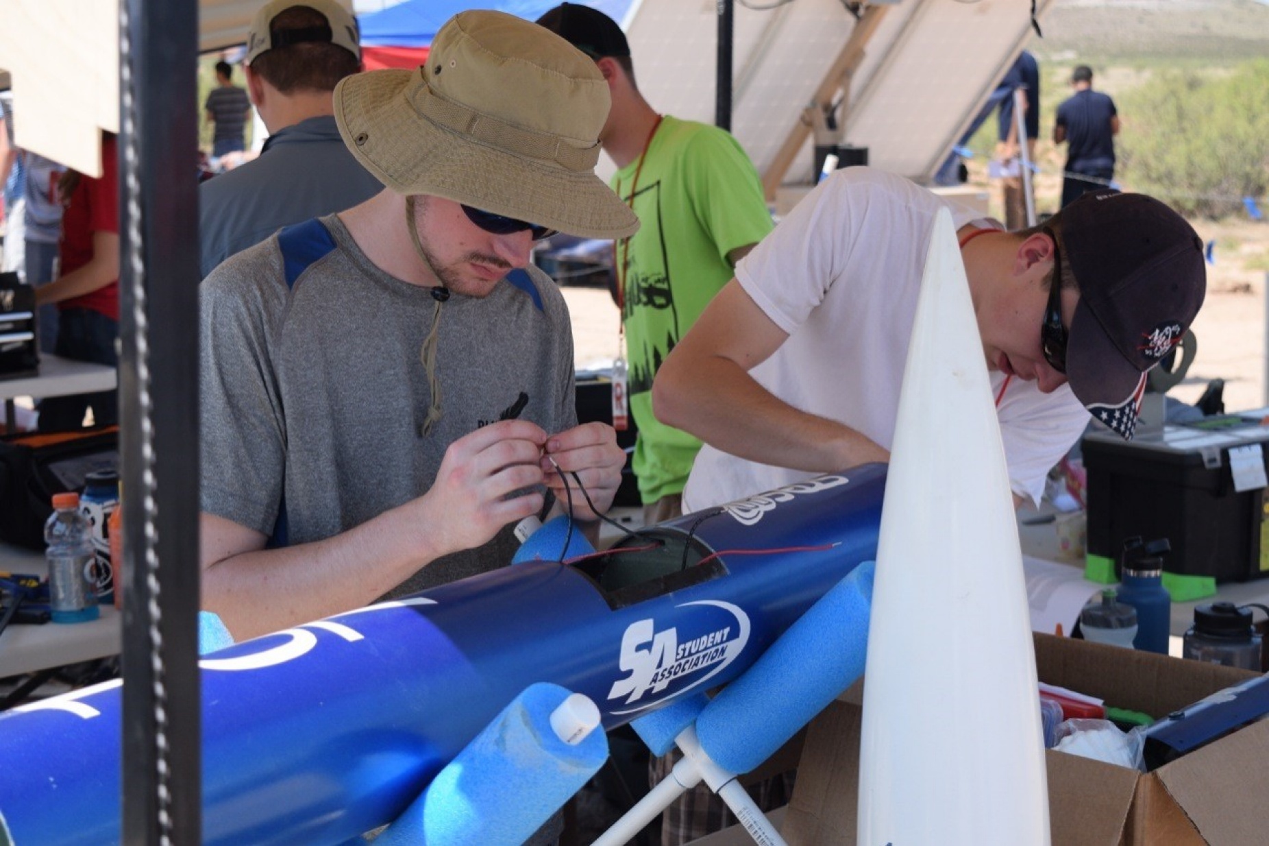 Gabriel Surina and Jacob Henry make adjustments to the avionics system. 