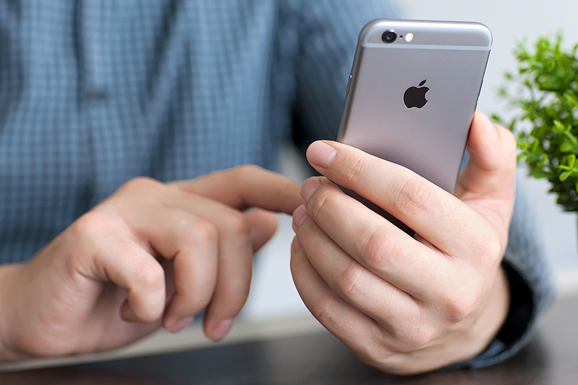Male hand holding an iPhone. 