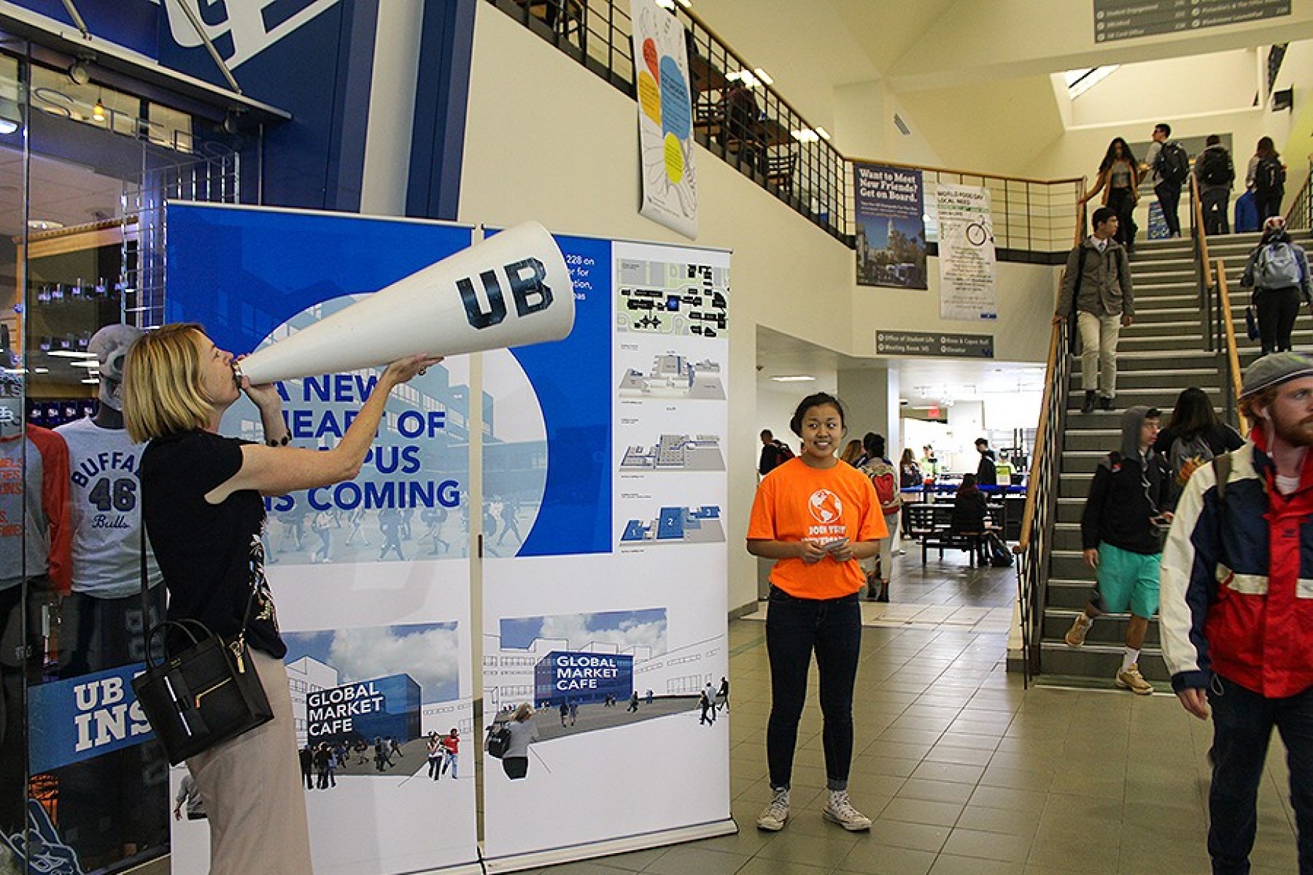 Kelly Hayes McAlonie, director of capital planning at UB and member of the Steering Committee for the global marketing café, uses a megaphone to attract students’ attention for the focus groups. 
