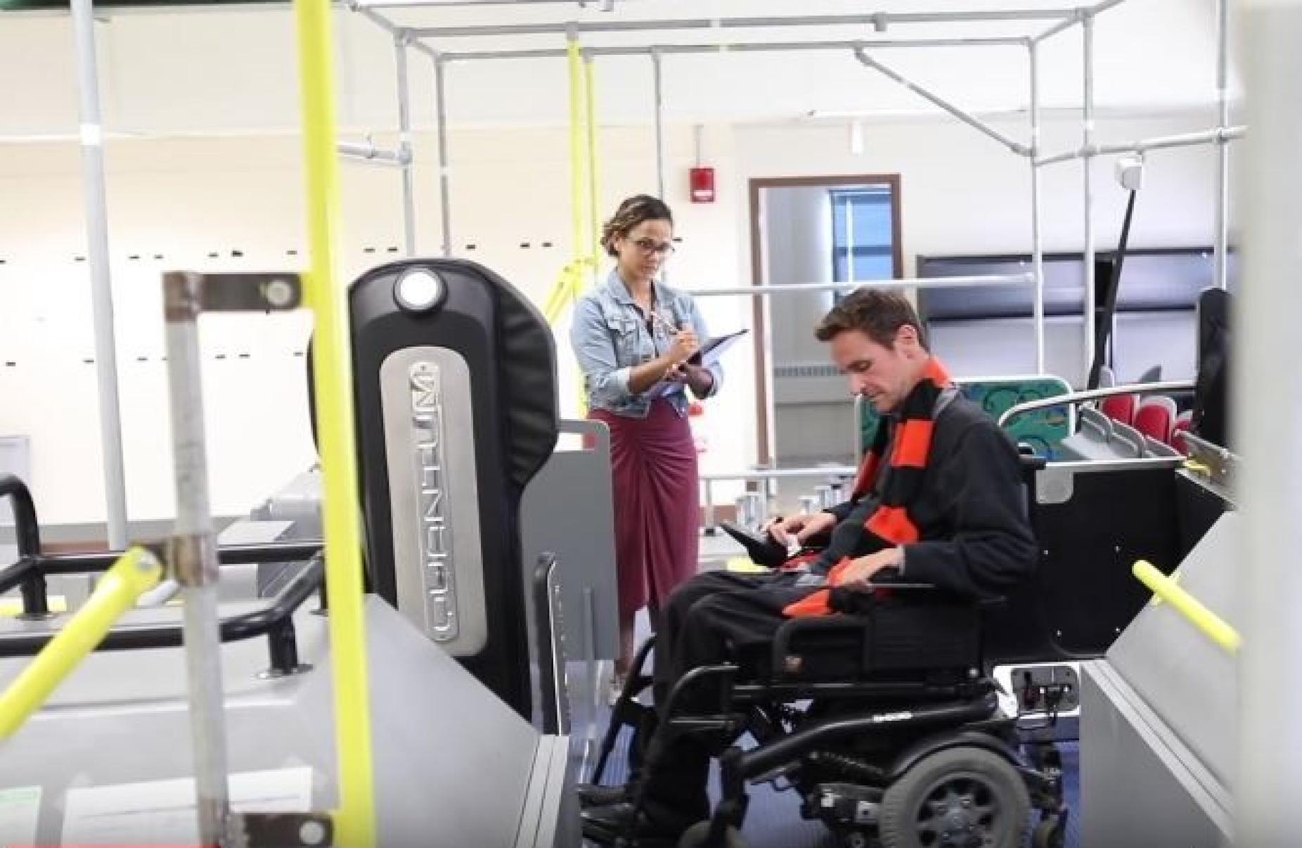 Man in wheelchair testing a securement system in UB's Idea center. 