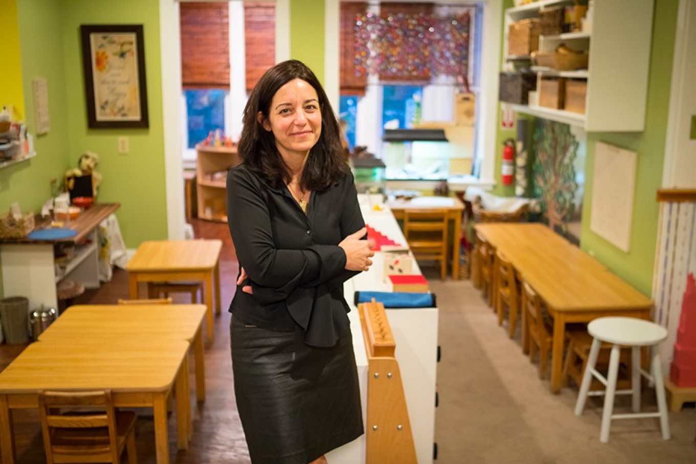 Portrait of Anna Liuzzo, UB alumna and founder of Roots of the Future Montessori preschool, pictured in a classroom. 