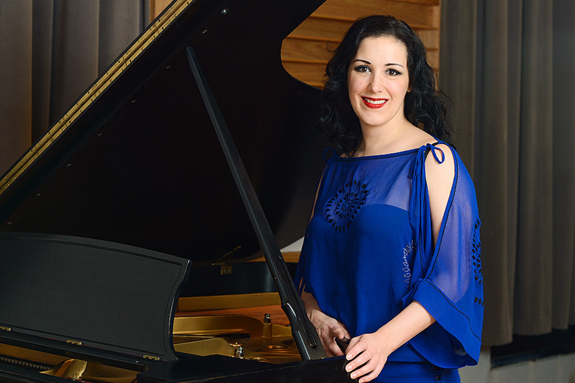 Tiffany Du Mouchelle in front of a grand piano. 