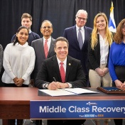 Gov. Andrew Cuomo signs legislation launching the second phase of the Excelsior Scholarship program during a visit to the Jacobs School of Medicine and Biomedical Sciences. 