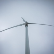 Photo illustration featuring miniature figurines repairing an electronic device. 