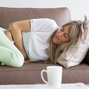 Young woman experiencing IBS pain. 