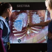 Two female medical student study anatomy using new technology available at the medical simulation center. 