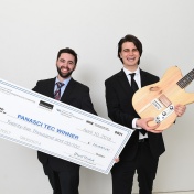 panasci winners Ryan Jaquin, holding a big check, and Shane Nolan, holding a guitar. 