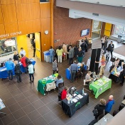 overview of information tables in the lobby of UB's Arthur O. Eve Educational Opportunity Center for the Refugee Health Summit. 