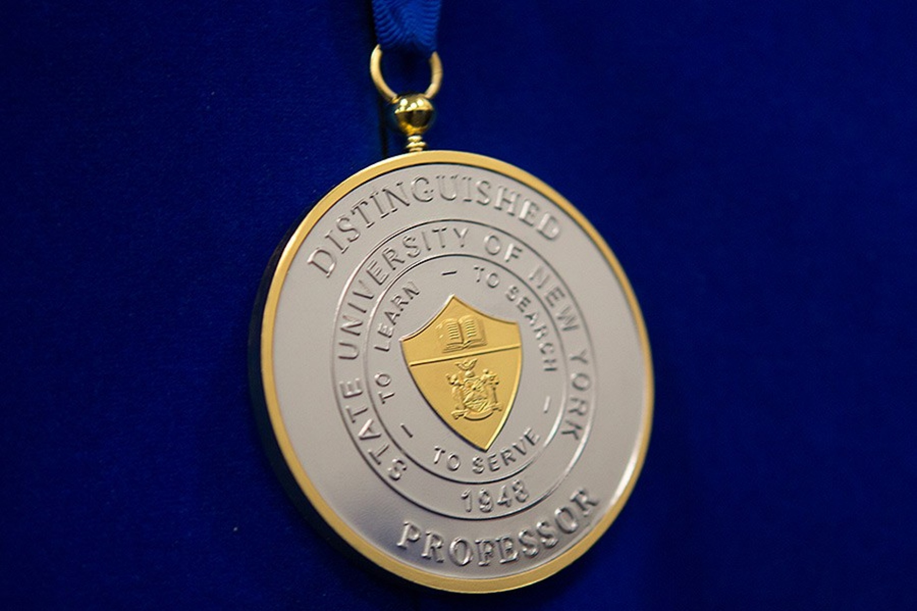 SUNY Distinguished Professor medallion.