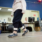 Photo of an older woman walking in a UB lab as part of a research study. 