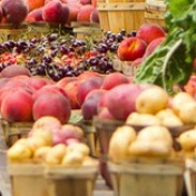 Table at farmers' market filled with produce. 