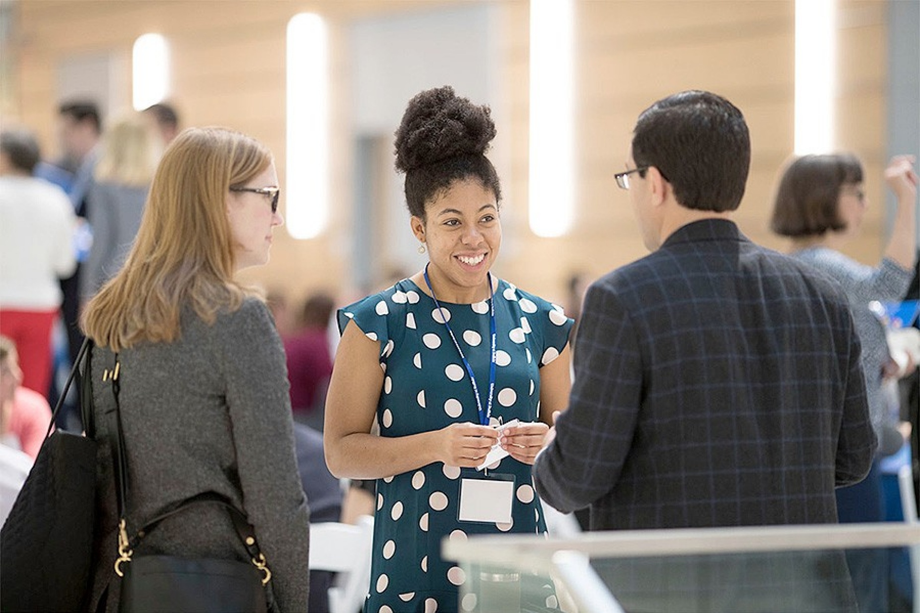 CLOE conference participants standing together, chatting. 