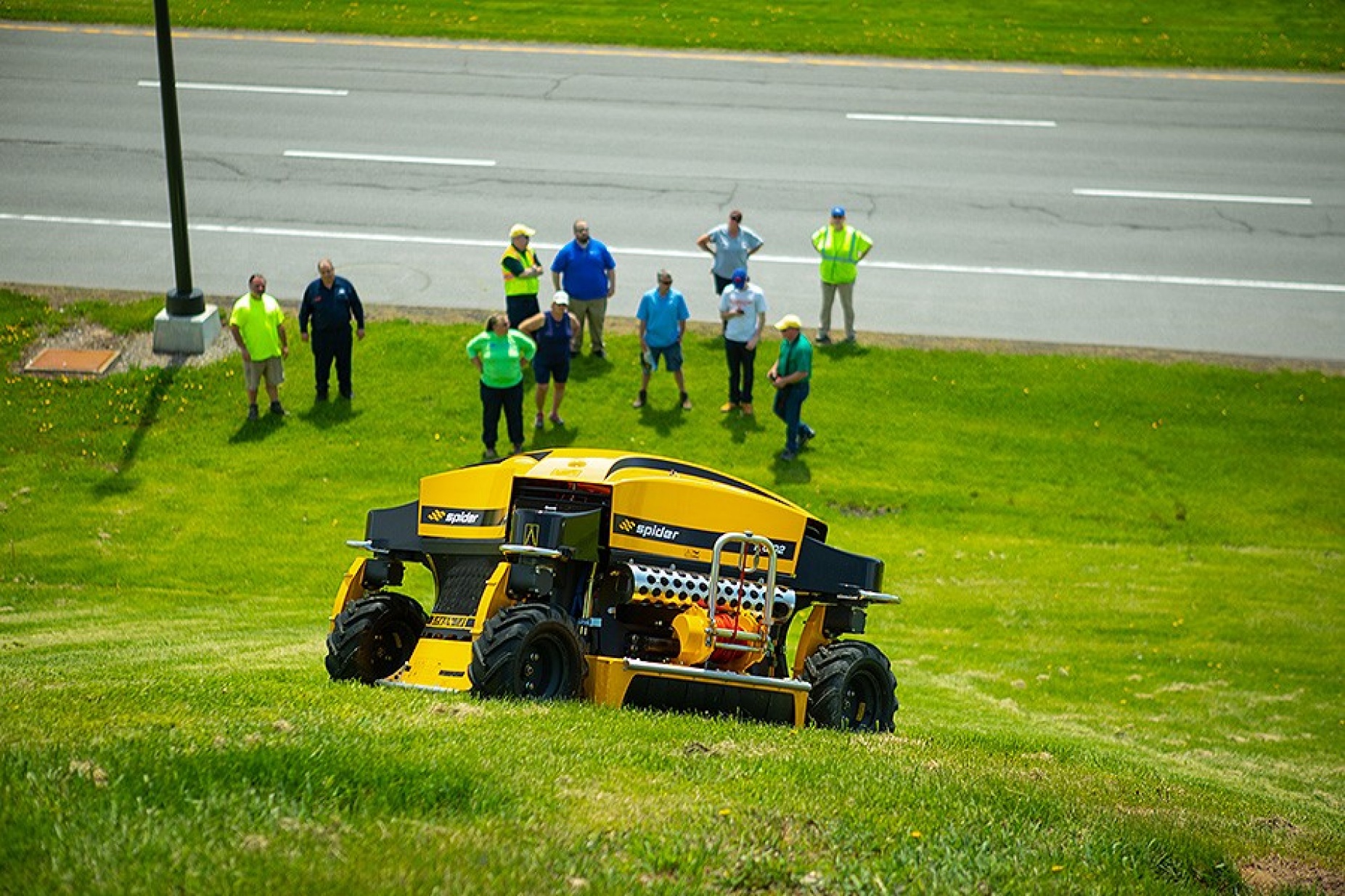 The Spider, a remote-controlled mowing unit, with all-wheel drive and all-wheel steering was demonstrated on the hillside of Walter Kunz Stadium. 