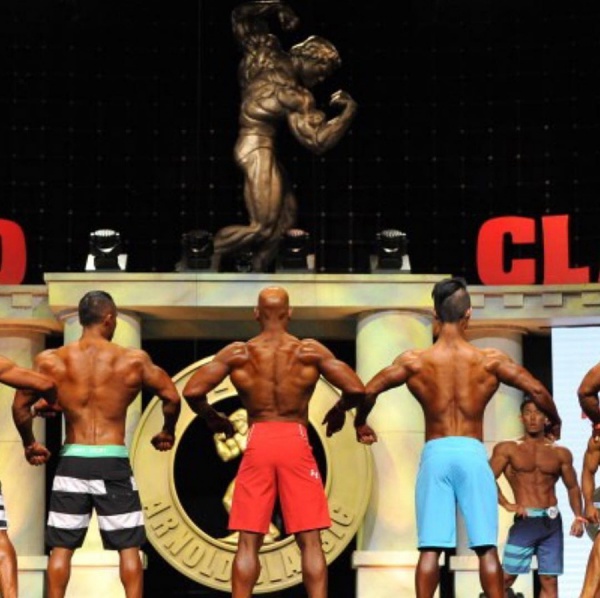 Jerome Shanklin (center, red shorts) competes in "Men's Physique," a new division of the the premier amateur physique organization in the world, the National Physique Committee. 
