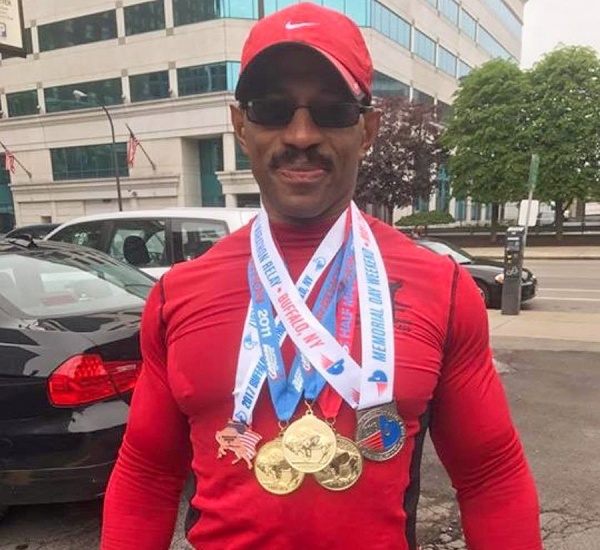 Jerome Shanklin wearing the medals from his previous marathons. 